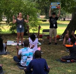 Young people teaching a 5-Day Club in a park